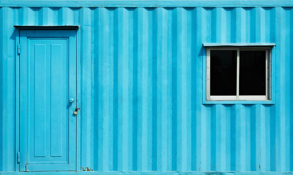 Container wall with painted door and sliding window