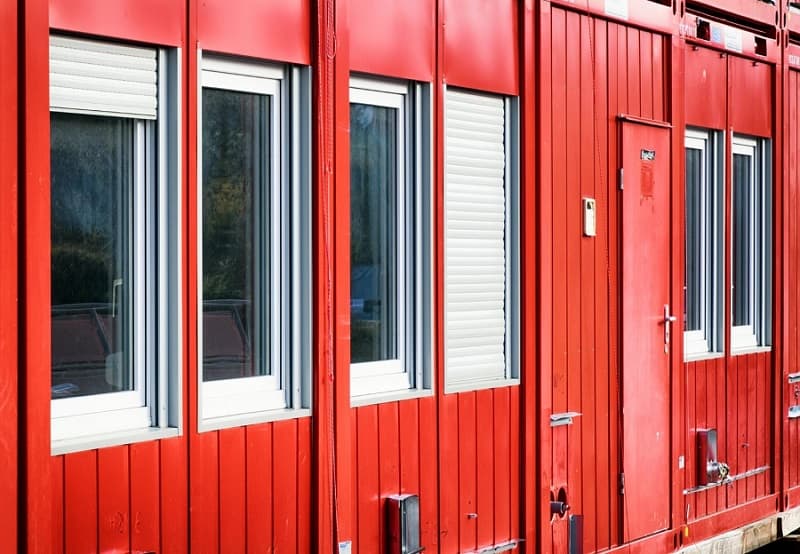 Container office with roller-shutter windows and secure door