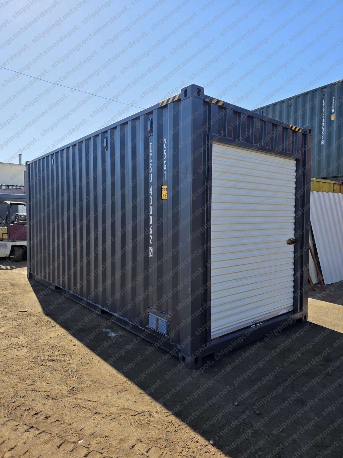 Gray shipping container with roll-up door modification