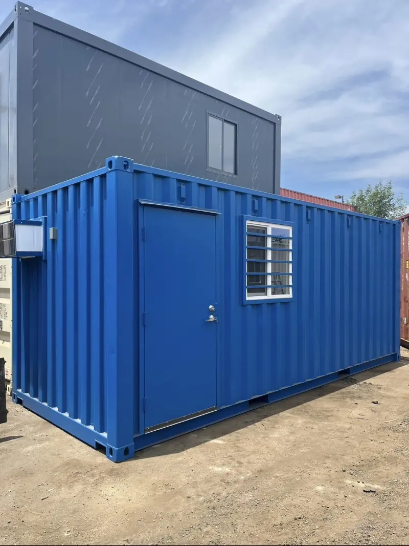Blue shipping container office modification with man door and window